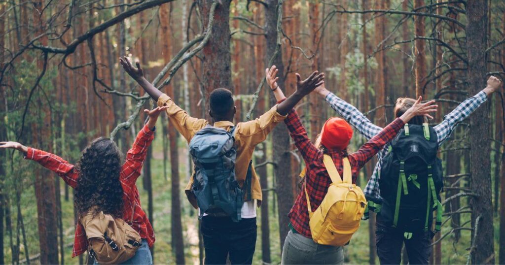 backpacking-friends-hiking-together-through-a-forest-trail