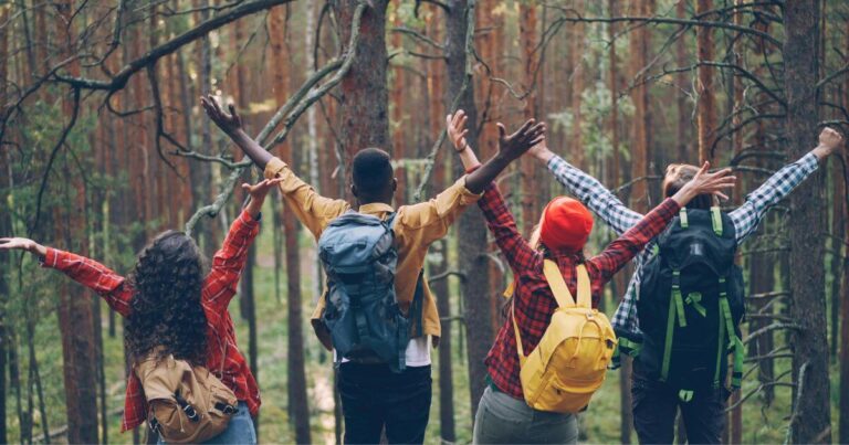 backpacking-friends-hiking-together-through-a-forest-trail